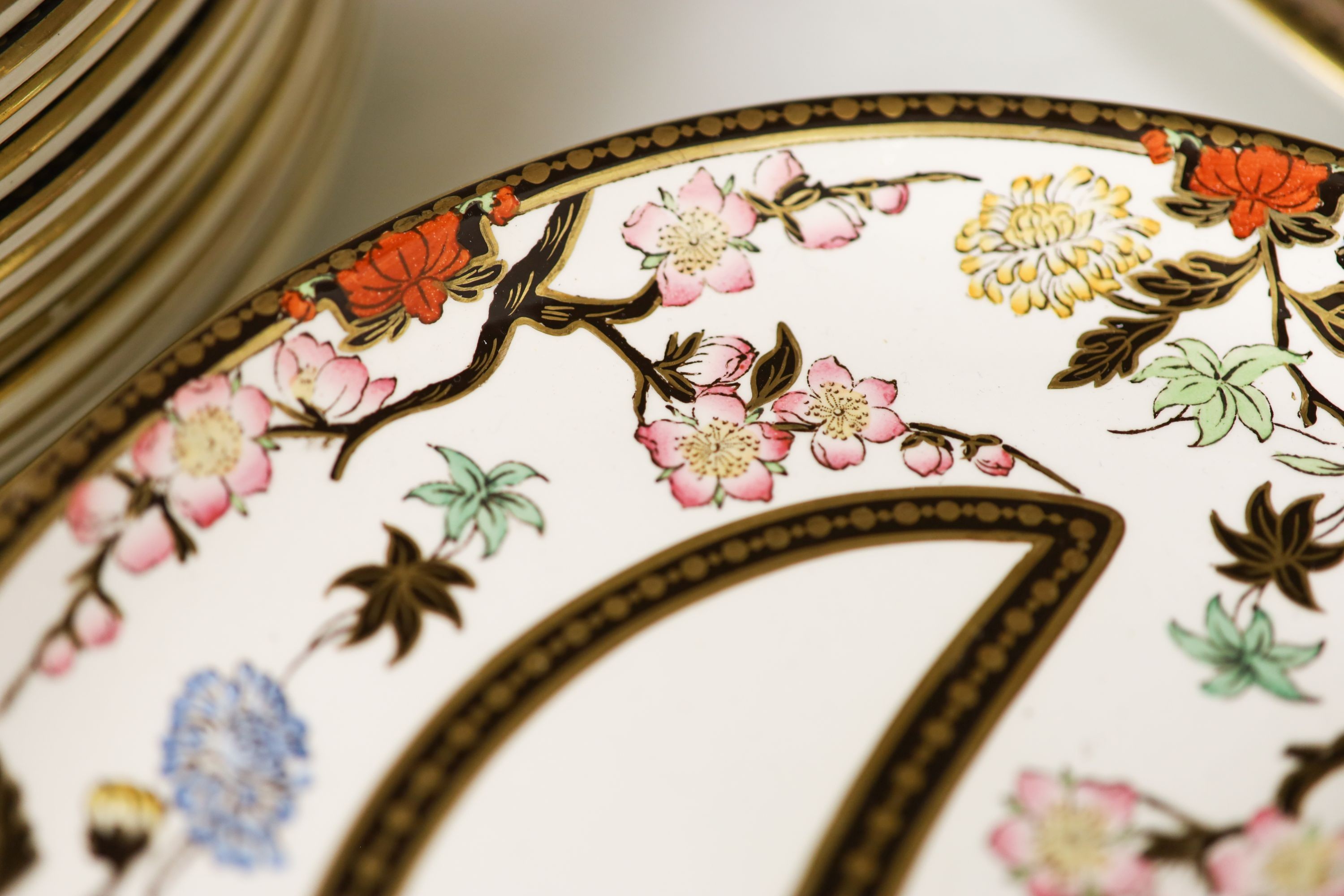 A Wedgwood Crescent pattern creamware part dinner service, the borders decorated with pink blossoms and chrysanthemums (approx. 65 pieces)